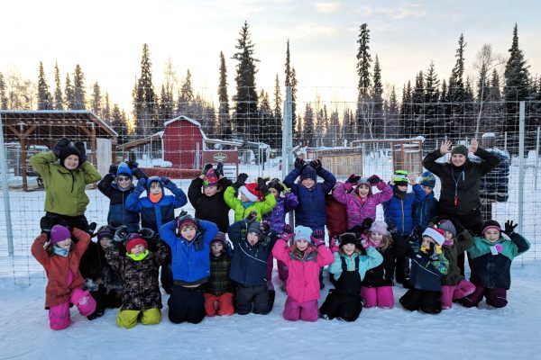 Photo courtesy of Moira O'Malley. Moira O'Malley, left, poses with her Watershed Charter School students during a field trip to the Fairbanks ice park last winter. O'Malley's class will follow her this fall as she participates in a 55-day research expedition in the eastern Arctic Ocean.