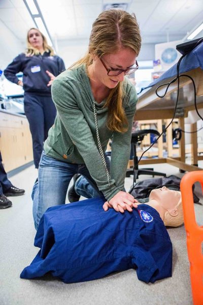 Photo courtesy College of Natural Science and Mathematics. A participant in a previous Alaska Interior Medical Education Summit gets hands-on experience practicing CPR.