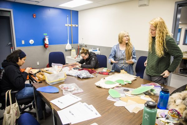Instructor Cheryl Thomson, second from right, teaches a fur hat sewing course Thursday, Oct. 11, 2018, in the recently completed Leonhard Seppala Arts Building. UAF photo by JR Ancheta.
