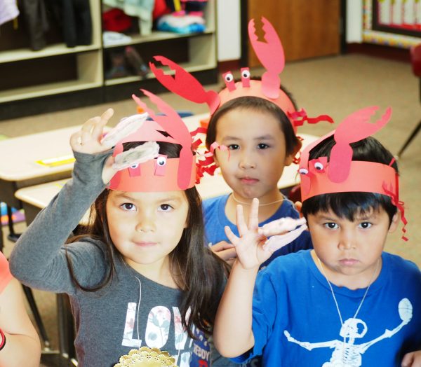 Heather McFarland photo. St. Paul Island students show off their scallop finger puppets and king crab crowns during Bering Sea Days.