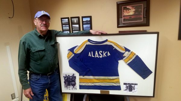 Photo courtesy of Russell Knapp. UAF alumnus Russell Knapp, class of 1969, poses with his club hockey sweater, which he donated to the university. He also recreated six additional sweaters from archived photos dating back to 1935.