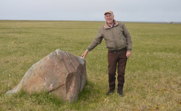 Photo by Ben Jones. Jim Webster, of Webster's Flying Service, stands next to a tundra boulder about four miles inland from the Beaufort Sea coast.