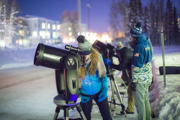 UAF photo by JR Ancheta. Members of the public view stars during Astropalooza on Dec. 1, 2017, outside the Reichardt Building.