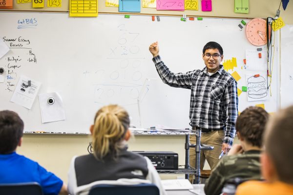 UAF photo by JR Ancheta. UAF School of Education intern Joe Bifelt  of Huslia, teaches multiplication to fourth grade students Friday, Oct. 5, 2018 at the Watershed Charter School gymnasium in Fairbanks.
