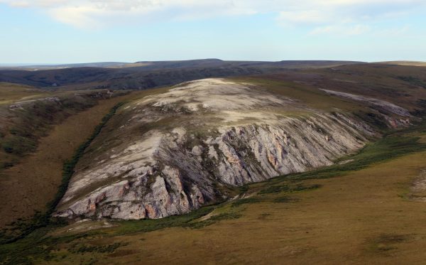 NPS photo by Jeff Rasic. This aerial view includes the Trail Creek Caves Site on Alaska's Seward Peninsula. Analysis of a 9,000-year-old tooth from the site has broadened understanding of Alaska's early people.