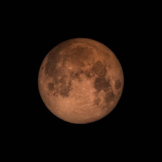 Photo by NASA's Goddard Space Flight Center. The moon takes on a reddish hue during a lunar eclipse.