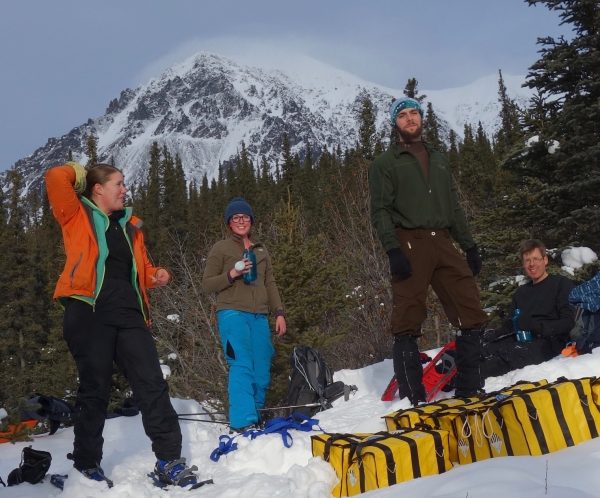 Photo by Ned Rozell. With Panorama Mountain in the background, from left, Lynn Kaluzienski, Elizabeth Berg, Cole Richards and Carl Tape take a break from stomping out a 1-kilometer snowshoe line across the Denali Fault near Cantwell.