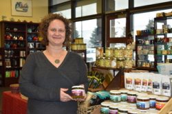 Photo by Paula Dobbyn. DeeAnn Apgar, owner of Summit Spice & Tea, displays a variety of Barnacle Foods products, including kelp pickles, on her Made in Alaska table at her Anchorage shop.