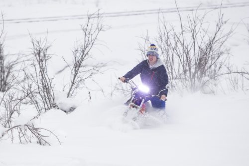 UAF photo by JR Ancheta. Jordan Osowski takes his homemade motorcycle-snowmachine hybrid out for a spin near the University of Alaska Fairbanks campus in March 2019.