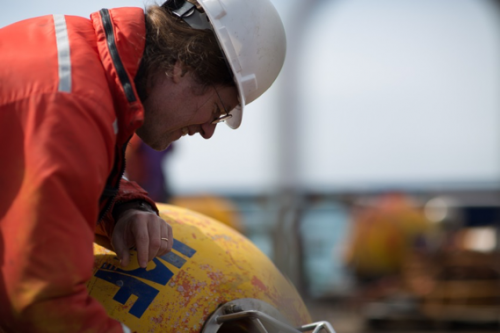 Photo courtesy of Seth Danielson. Seth Danielson helps recover a mooring during a late spring Arctic cruise.