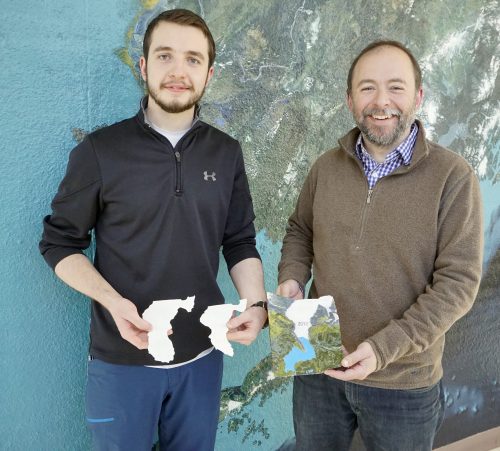 UAF photo by Fritz Freudenberger. Reyce Bogardus, left, and Matthew Balazs pose with their 3D printed scale model, a series of nesting plastic pieces representing the Mendenhall Glacier's ice volume at three points in history. They hope the model can help people visualize how much the glacier has retreated since 1948.
