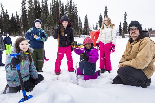 UAF photo by JR Ancheta. Anne Wien Elementary School fourth-graders practice measuring ice on March 25, 2019, on Noyes Slough with the help of Fresh Eyes on Ice researcher Allen Bondurant.