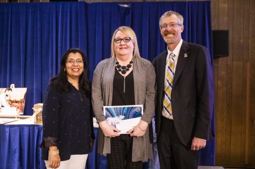 Deb Moore received her 35-year longevity award from Provost Anupma Prakash and Chancellor Dan White during the 2019 Staff Longevity Awards ceremony. UAF photo by JR Ancheta.