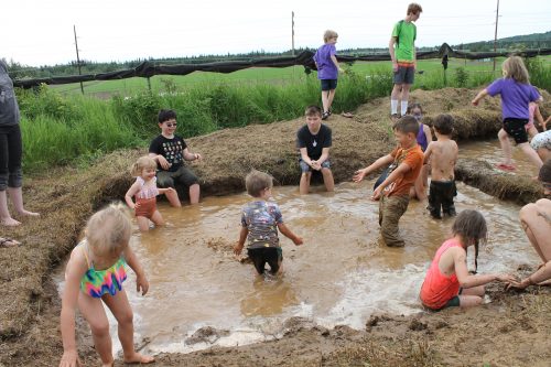 Photo by Debbie Carter. Celebrants at the 2018 Birthday Bash and Mud Day enjoy the mud pit.