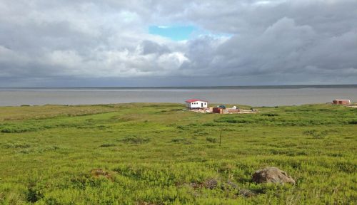 Photo courtesy of Aaron Cooke. A home built in 2016 sits above Baird Inlet at Mertarvik, about 12 miles southeast of Newtok. Residents of Newtok are gradually moving their village to the site on Nelson Island's north shore.