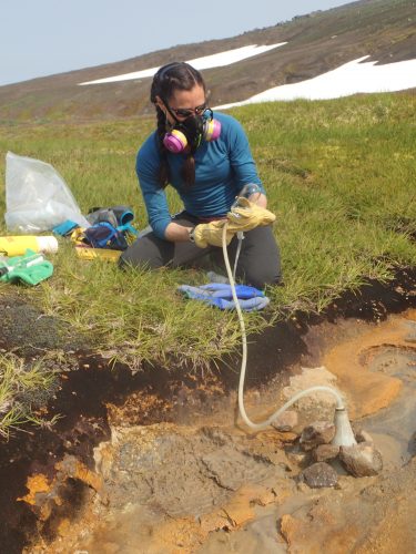 Photo by Peter Kelly. Taryn Lopez samples gases from Korovin Volcano on Atka Island in summer 2019.