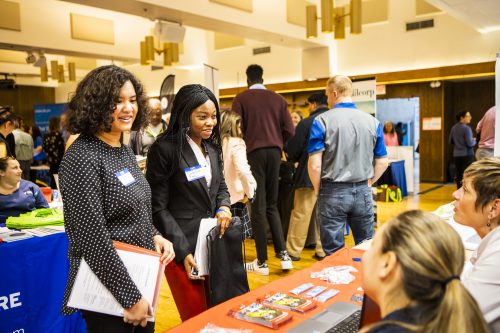 UAF photo by JR Ancheta. Attendees at the fall job fair speak to employers.