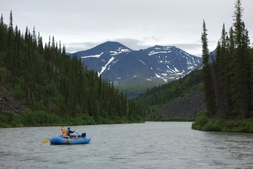 Photo by Ned Rozell. The Nenana River, on which this rafter floats, begins south of the Alaska Range's higher central spine. The river then turns northward and flows through a pass in that spine.