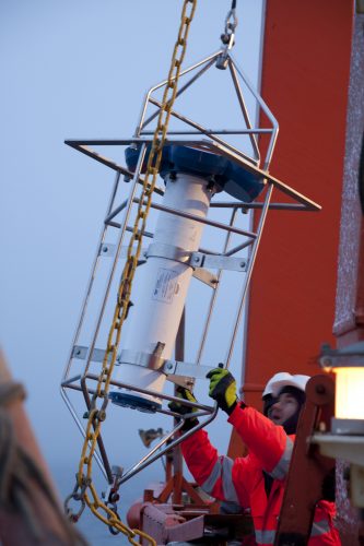 Photo courtesy of the Nansen and Amundsen Basins Observational System. Scientists prepare to deploy ocean moorings used to understand sea ice loss in the eastern Arctic Ocean.