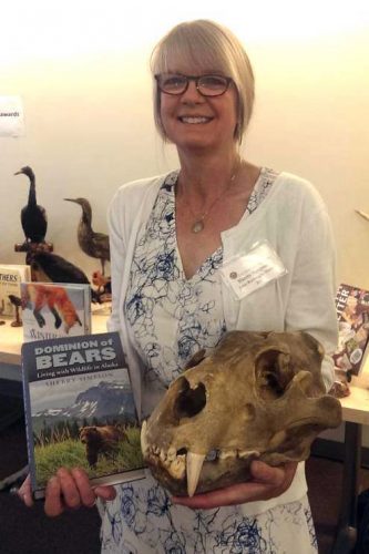 Photo by Scott Kiefer. Sherry Simpson holds her book “Dominion of Bears: Living with Wildlife in Alaska” after receiving the John Burroughs Medal for the work.