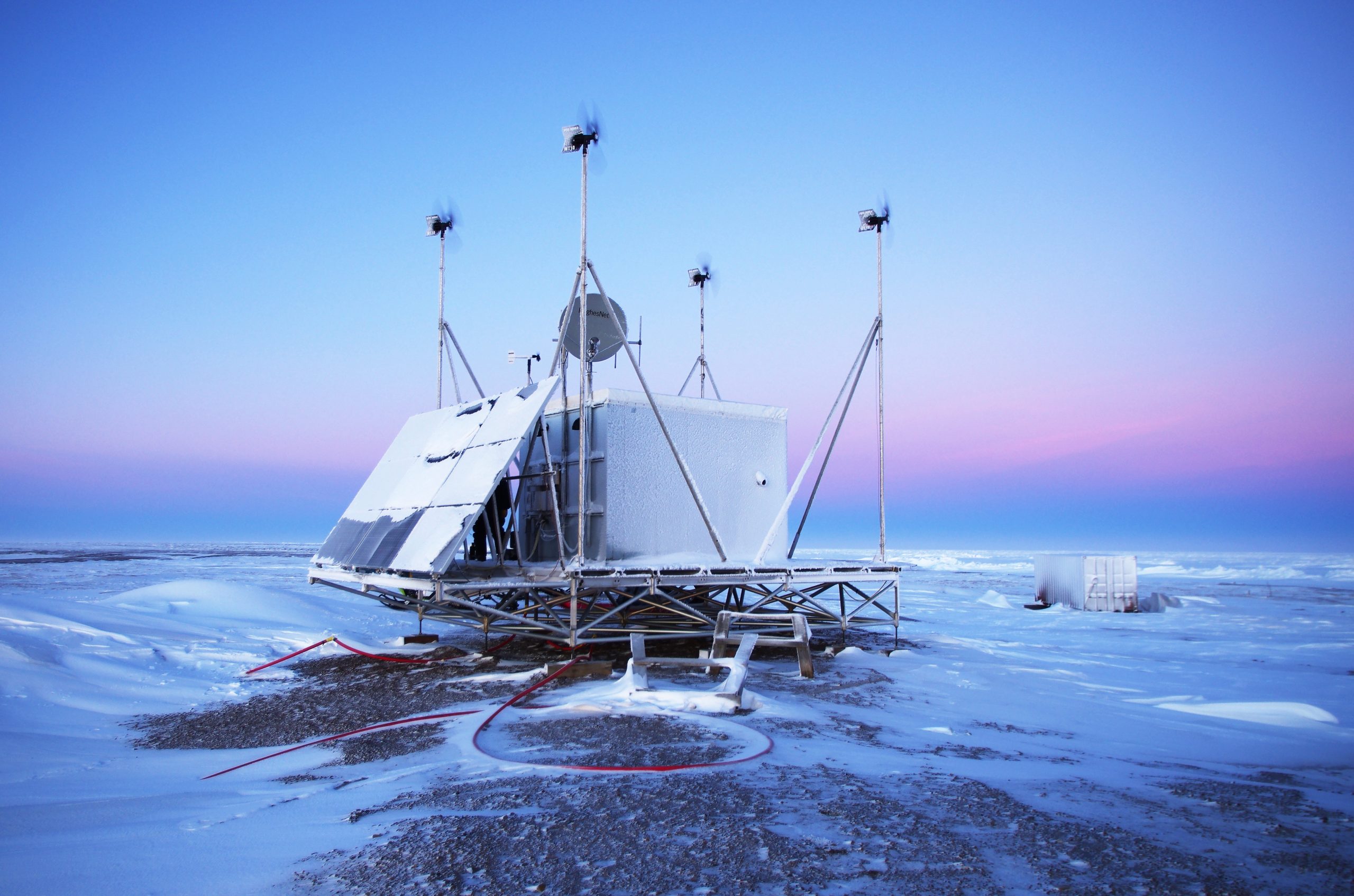 Photo by Hank Statscewich. A remote power module built at UAF operates at Cape Simpson, located 50 miles southeast of Utqiaġvik on Alaska's Arctic coast. The module has wind turbines, solar panels, wi-fi and electronics to support a high-frequency radar system that measures currents when the Beaufort Sea is ice-free.
