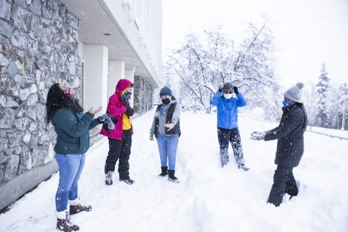 Students celebrate a heavy snowfall in November 2020. UAF photo by JR Ancheta.