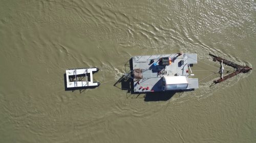 Photo by Paul Duvoy. An aerial view shows a hydrokinetic turbine platform at the Alaska Center for Energy and Power's Tanana River test site near Nenana in July 2020.