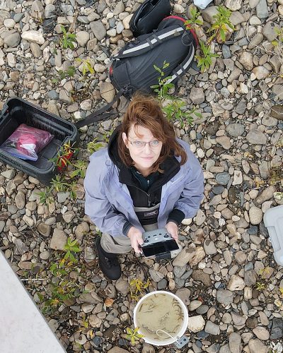Photo by Debra Lynne/TCC. Debra Lynne, a resources specialist with Tanana Chiefs Conference, uses a small unmanned aircraft to gather footage of the Chena River outside Fairbanks in summer 2020.