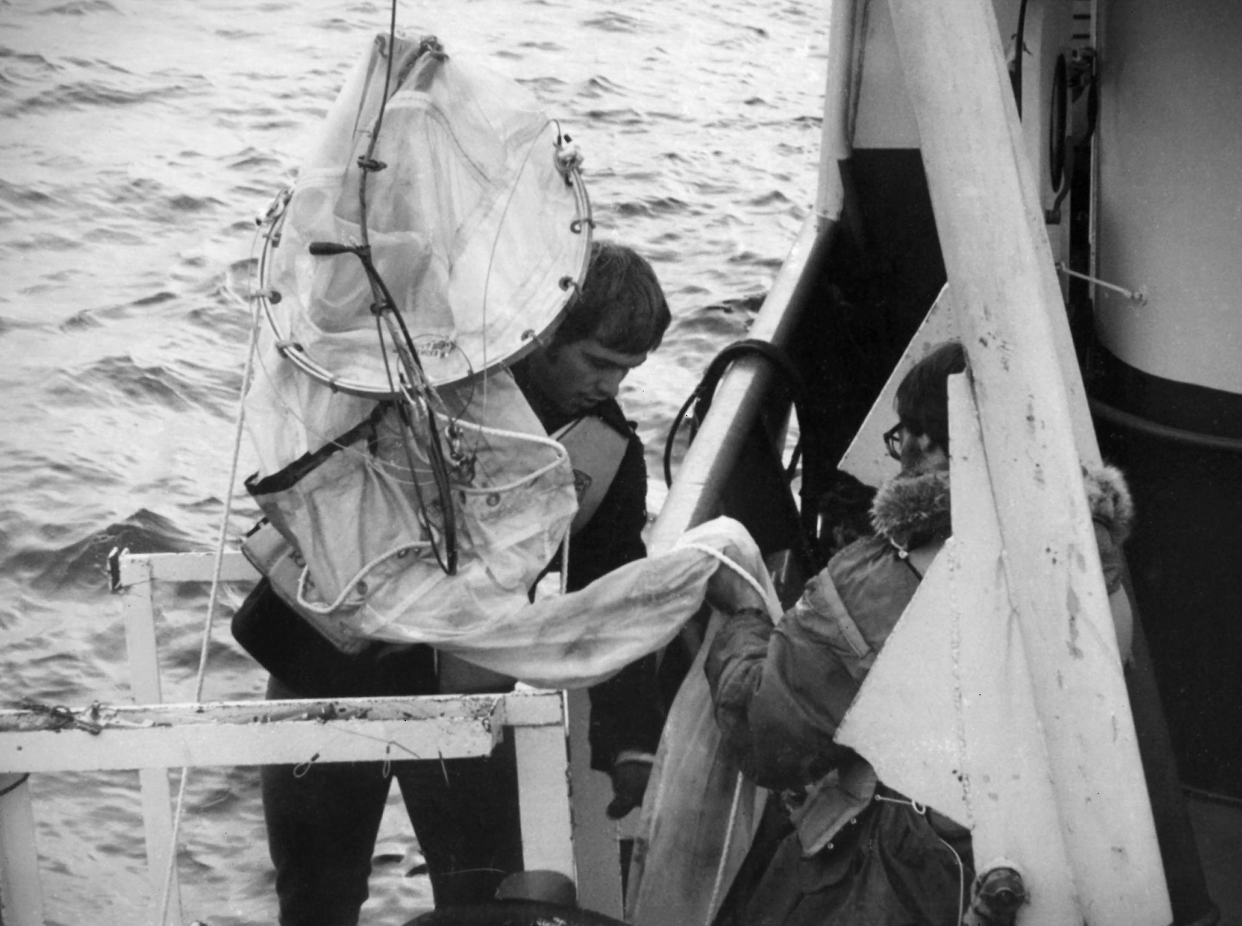 Photo courtesy of the Seward Marine Center. Marine technicians catch plankton by towing a net from Acona.