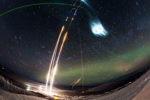 Photo by Zayn Roohi courtesy of NASA’s Wallops Flight Facility and Poker Flat Research Range. A time-lapse photograph captures the Super Soaker launches on Jan. 25-26, 2018. Three rockets launched with the mission, two using vapor tracers to track wind movement and one releasing a water canister to seed a polar mesospheric cloud. The green laser beam visible at the top left is the LIDAR beam used to measure the artificial cloud.