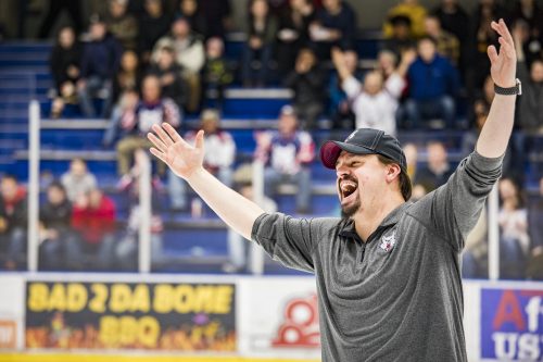 UAF photo by JR Ancheta. UAF student Tommy Nelson cheers at the Big Dipper ice arena in 2018 while doing on-ice promotions for the Fairbanks Ice Dogs hockey team. Nelson's goal is to become a general manager of a professional sports organization.