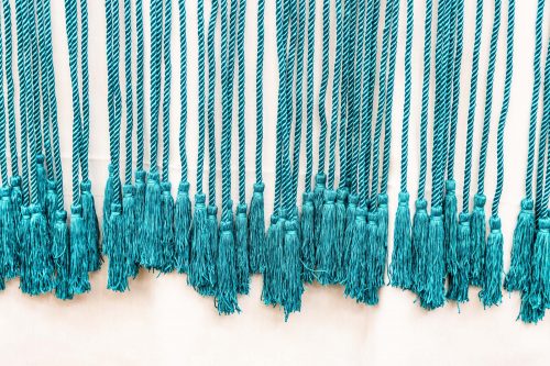Teal cords are used to symbolize the success of graduates who are the first in their family to earn a bachelor's degree. UAF photo by JR Ancheta.