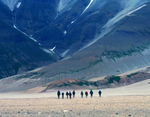 Photo by Ned Rozell. Hikers traverse the Valley of Ten Thousand Smokes on the Alaska Peninsula, walking on a sheet of ash and volcanic rock more than 500-feet thick.