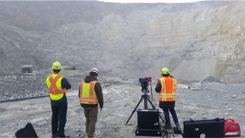 Field scans being made of exposures at Fort Knox Mine northeast of Fairbanks. The scans serve as additional ground validation for airborne hyperspectral data. Geophysical Institute photo.