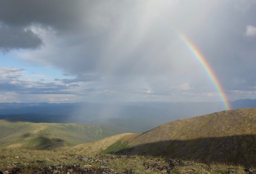 Photo by Ned Rozell. A rainbow forms in a midsummer shower over tundra-covered uplands in Interior Alaska. Across Alaska, the average date of summer's greatest warmth falls anywhere from a few weeks to a few months after the summer solstice.