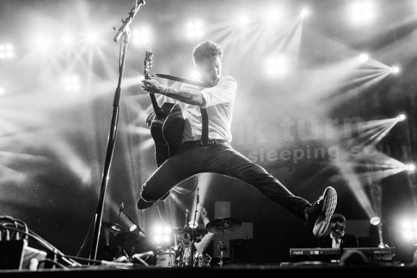 Frank Turner jumping on stage during a performance
