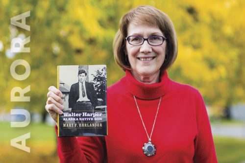 Woman holding a book cover of book on Walter Harper