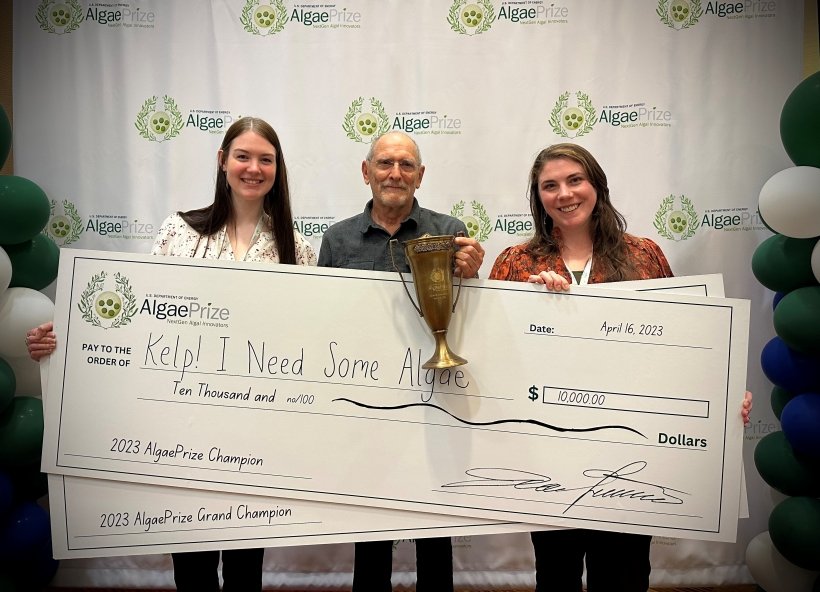 Muriel Dittrich, Mike Stekoll and Tamsen Peeples show off their trophy and ceremonial checks at the AlgaePrize competition.