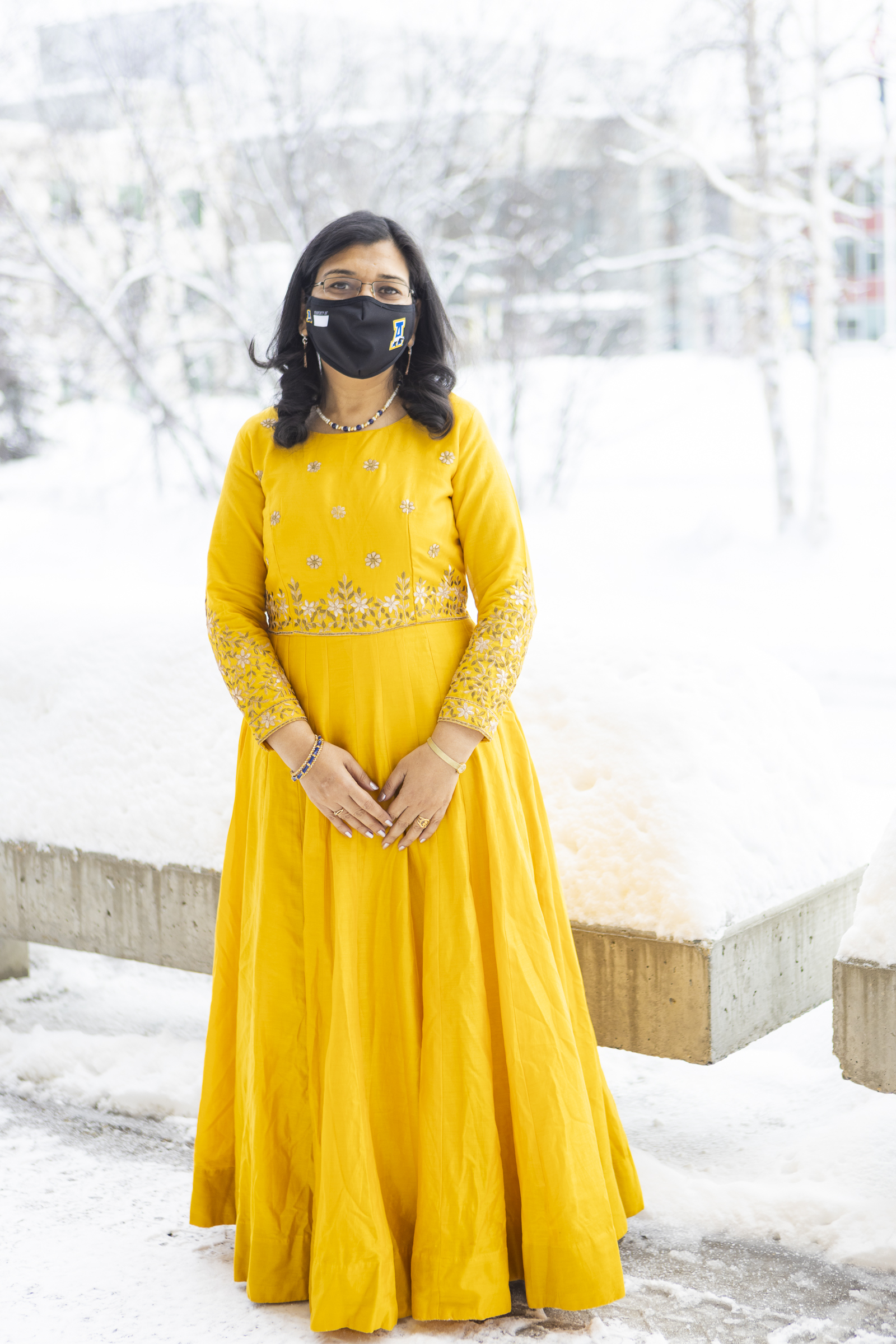 Anupma Prakash wearing a mask and gold dress