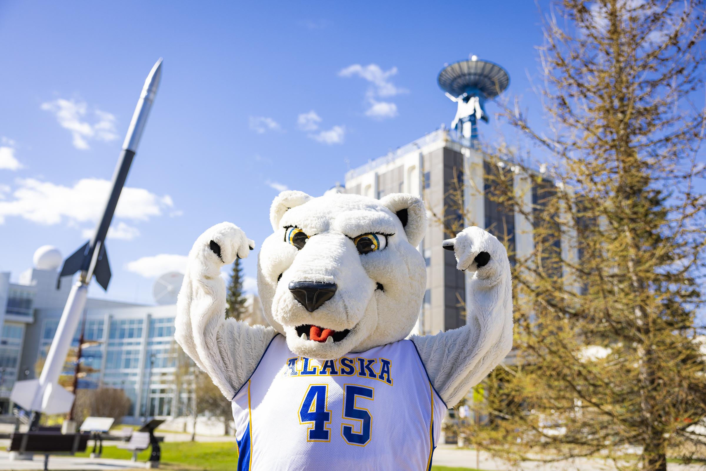 Nook, the UAF mascot, stands in front of the Akasofu and Elvey buildings,  which house some of the more than two dozen research units and facilities participating in the Arctic Research Open House. 
