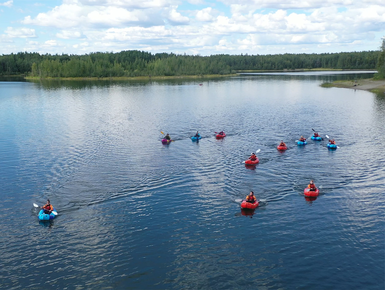 Kayakers paddle on a lake
