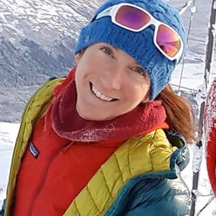 Smiling woman with skis