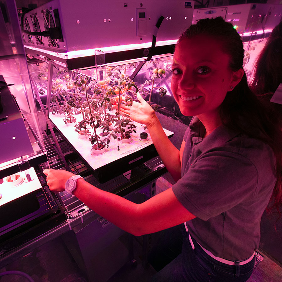 Ayla Grandpre, a 2017 NASA intern from Rocky Mountain College in Billings, Mont., with plant growth specimens.