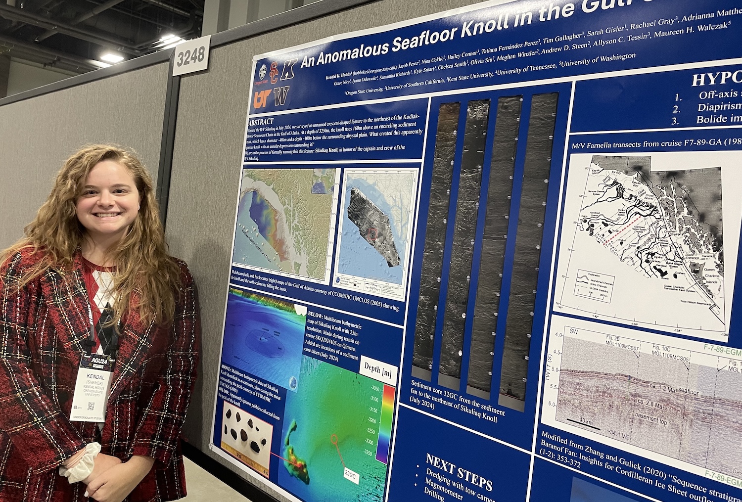 A woman stands next to a scientific poster.