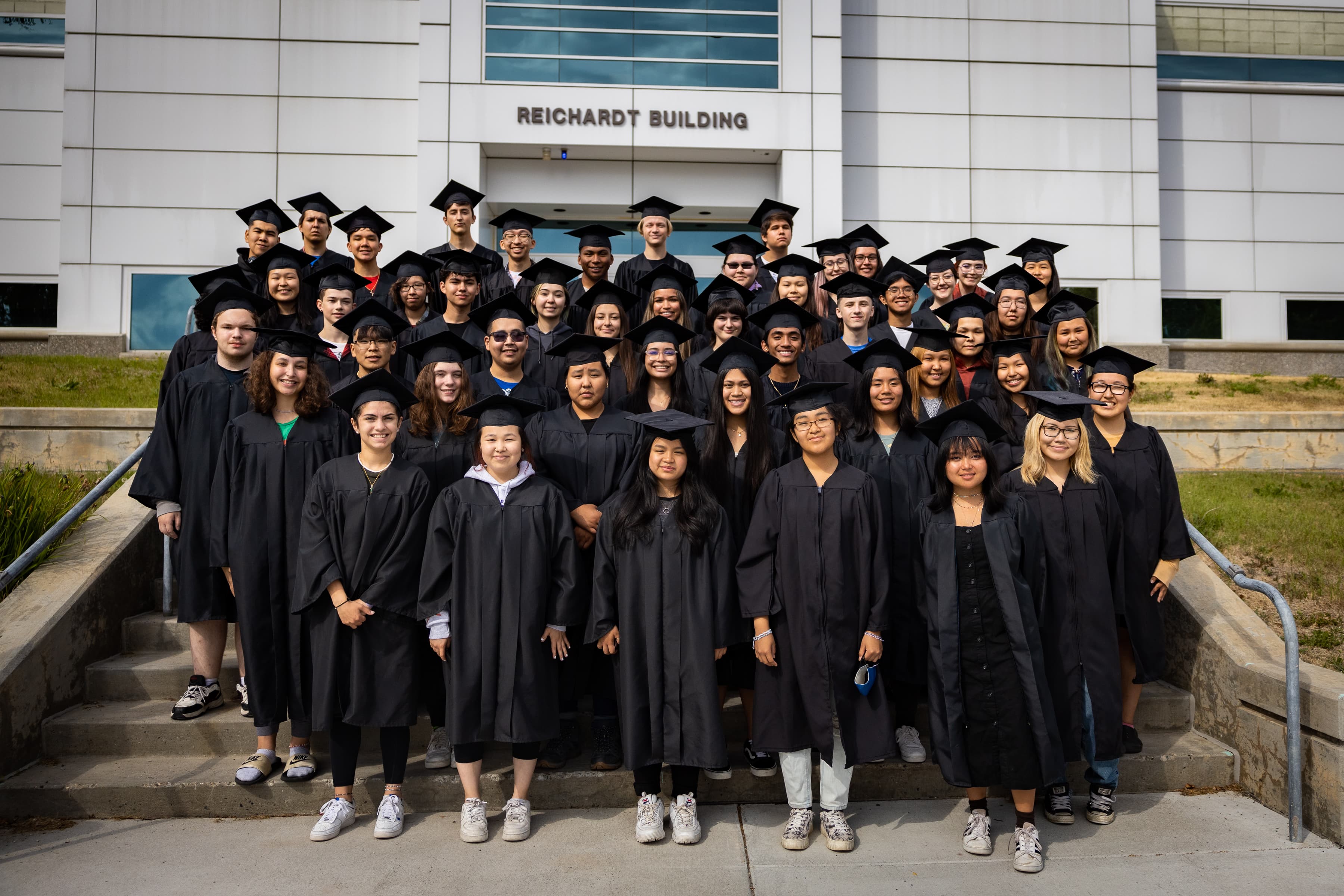 RAHI Class of 2022 take a group photo outside of the Reichardt Building on West Ridge before attending their graduation rehearsal on July 13, 2022..