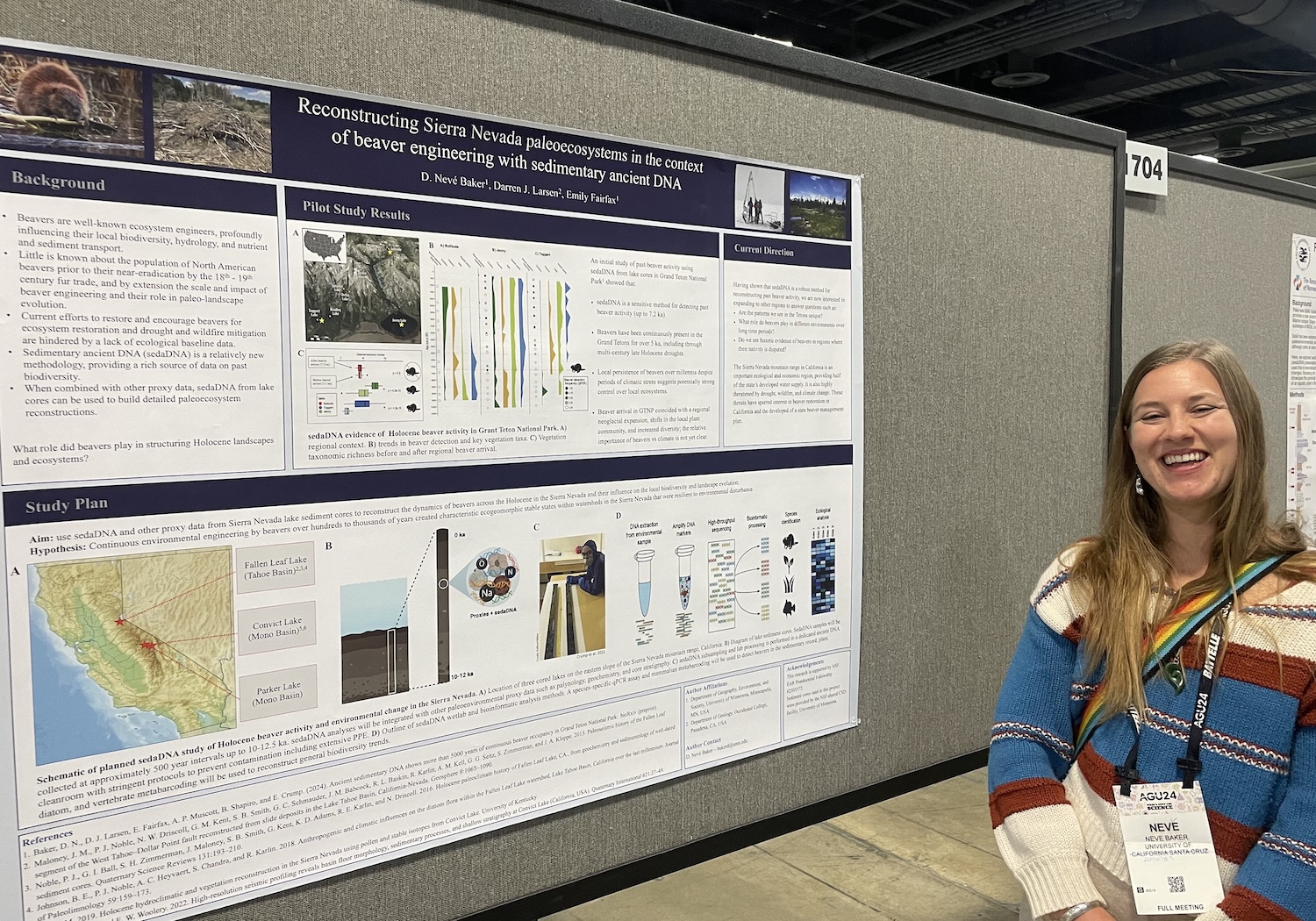 A woman stands next to a scientific poster.