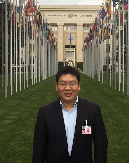 A man stands in front of the United Nations building