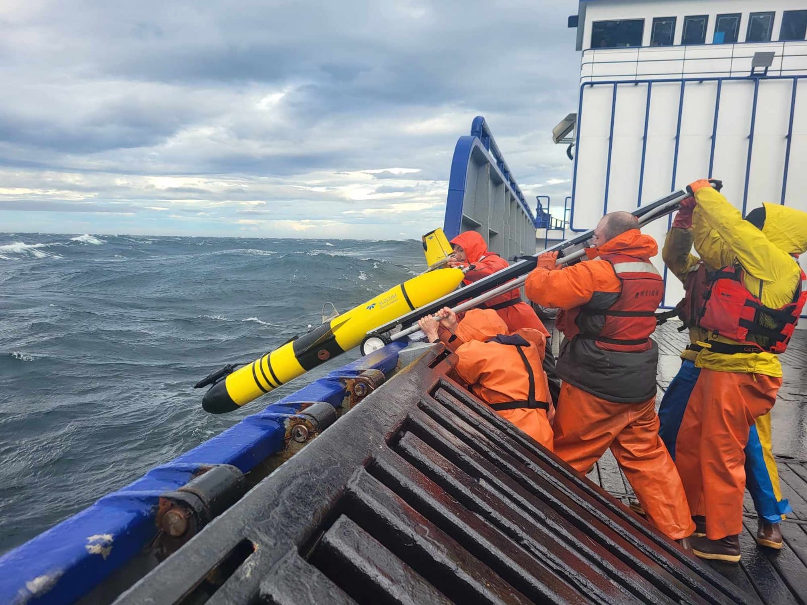 Scientists aboard the patrol vessel Stimson launch the glider Shackleton in May 2024 to search for tagged juvenile crabs in Bristol Bay.