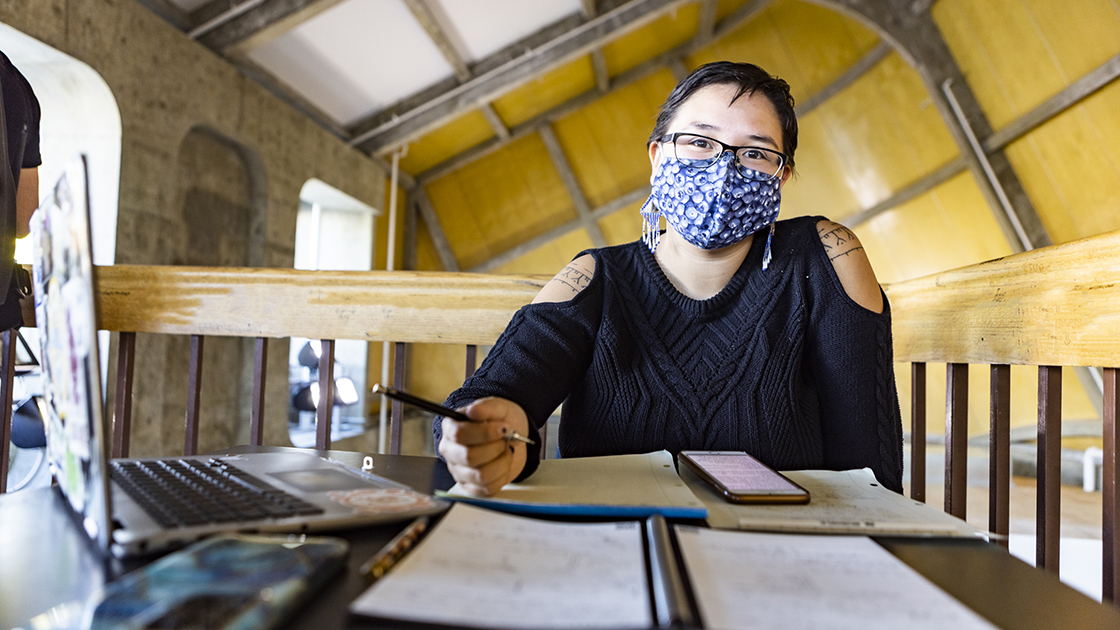 woman at desk with mask