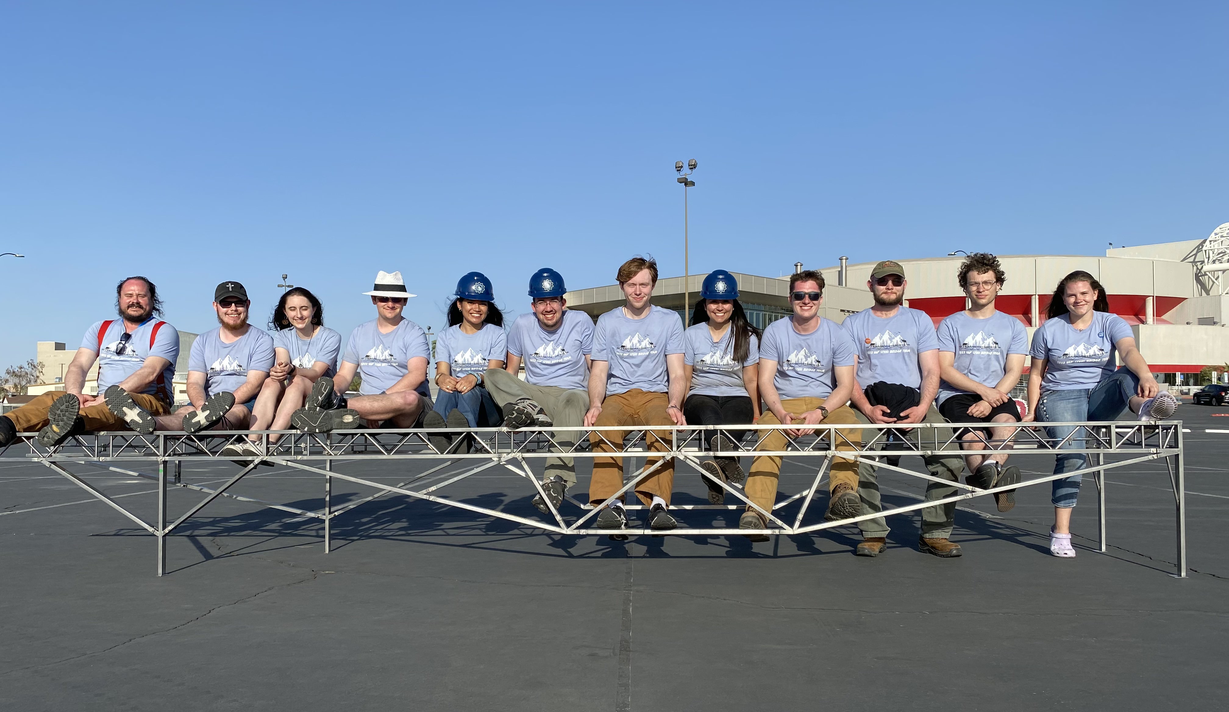 Members of the UAF steel bridge team sitting on their bridge